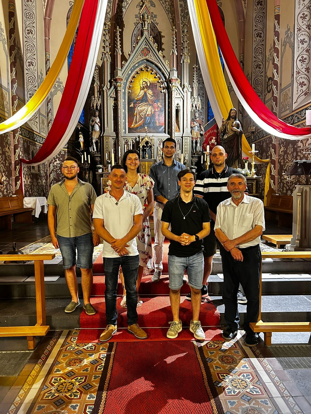 Gemeinschaft vor dem festlich geschmückten Herz-Jesu-Altar
